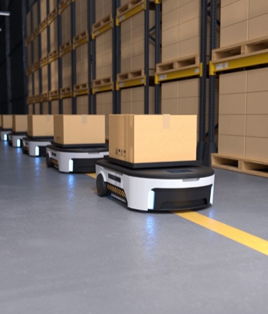 Autonomous mobile robots carrying cartons along a line of warehouse racking