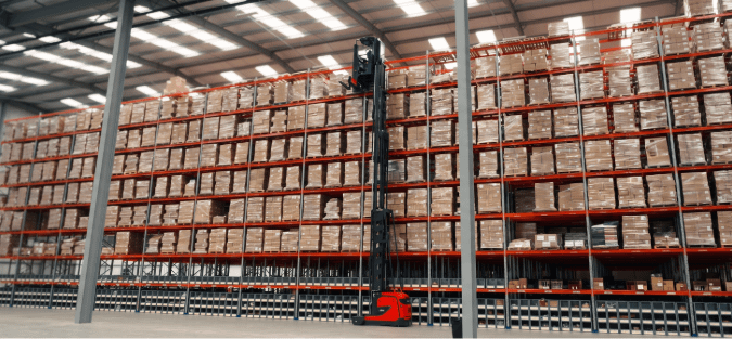 Autonomous picking robot navigating warehouse aisles beside stacked shelving