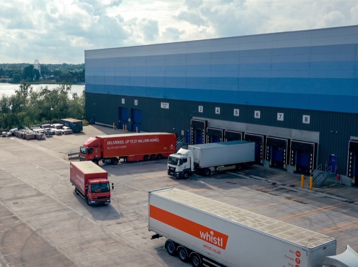Lorries at the loading bays of a large distribution warehouse
