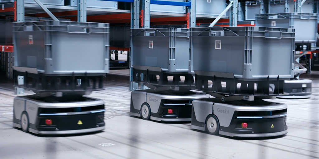 Third party logistics robots processing e-commerce fulfilment orders in a modern 3PL warehouse